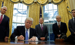 Donald Trump firma con marcadores negros